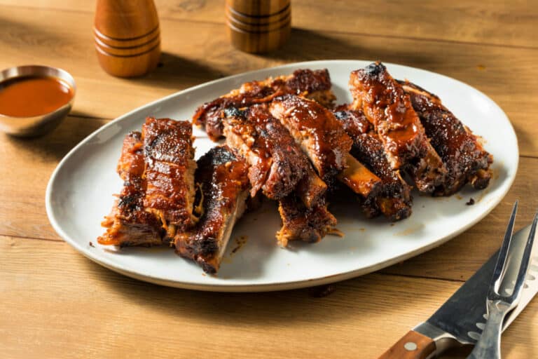 Sliced St Louis Ribs served ona white platter