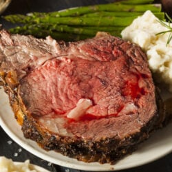 sliced ribeye roast served with potatoed and vegetabls