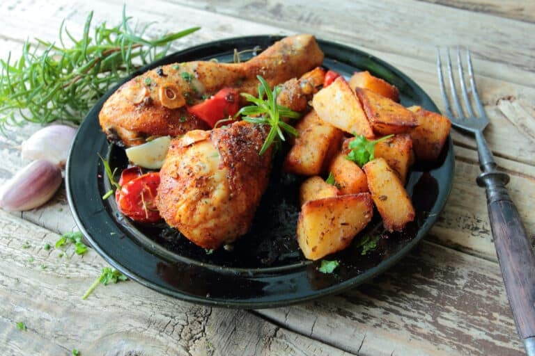 air fryer chicken legs on a plate with crispy air fryer potatoes