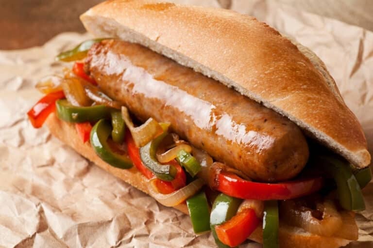 air fryer Italian sausage and peppers served on a sausage roll on brown paper