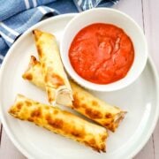 top down view of air fryer mozzarella sticks with marinara sauce