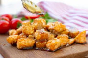 Air Fryer Honey Soy Salmon Bites That Are Flaky and Moist air fryer salmon bites with a honey, soy and garlic sauce on a board