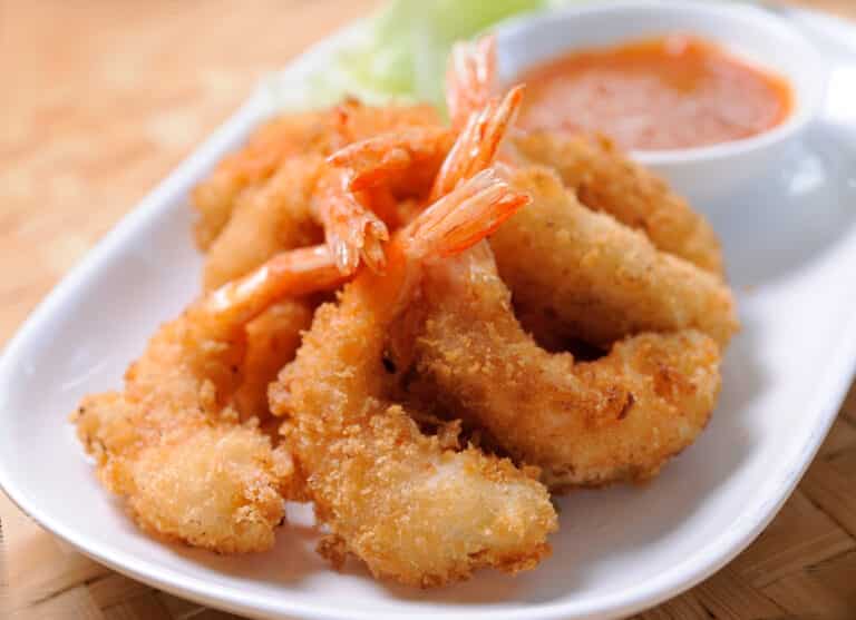 Air fryer shrimp with remoulade sauce served on a white plate