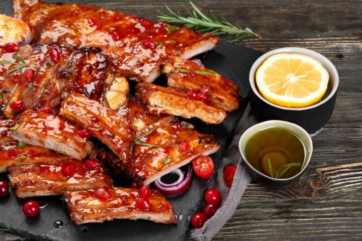 air fryer bbq ribs brushed with BBQ Sauce and served with lemon and sauce on the side