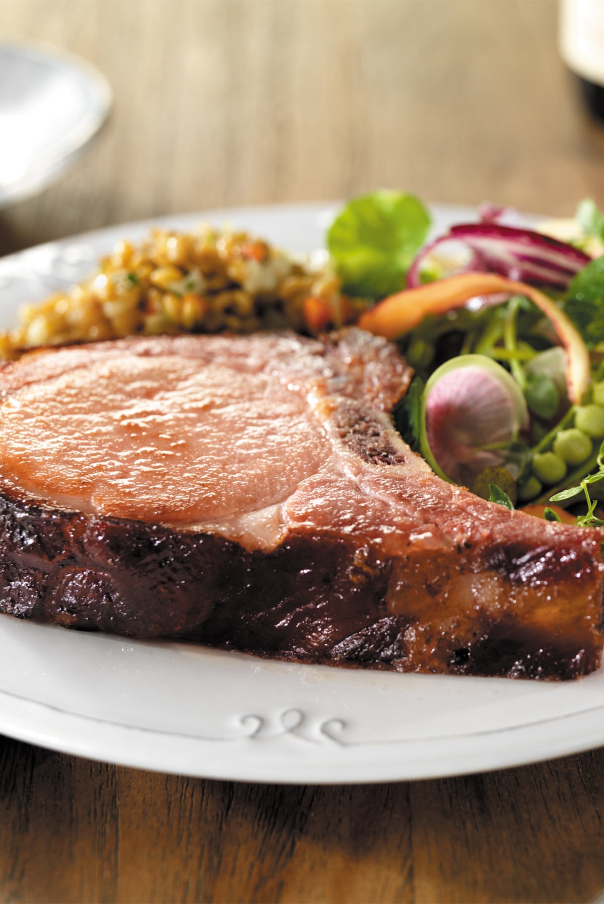 thick pan fried pork chops served with side dishes