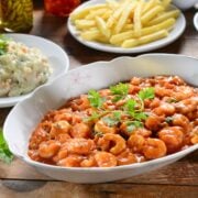 camarones a la diabla - spicy Mexican shrimp served in a white bowl with fries and slaw on the side