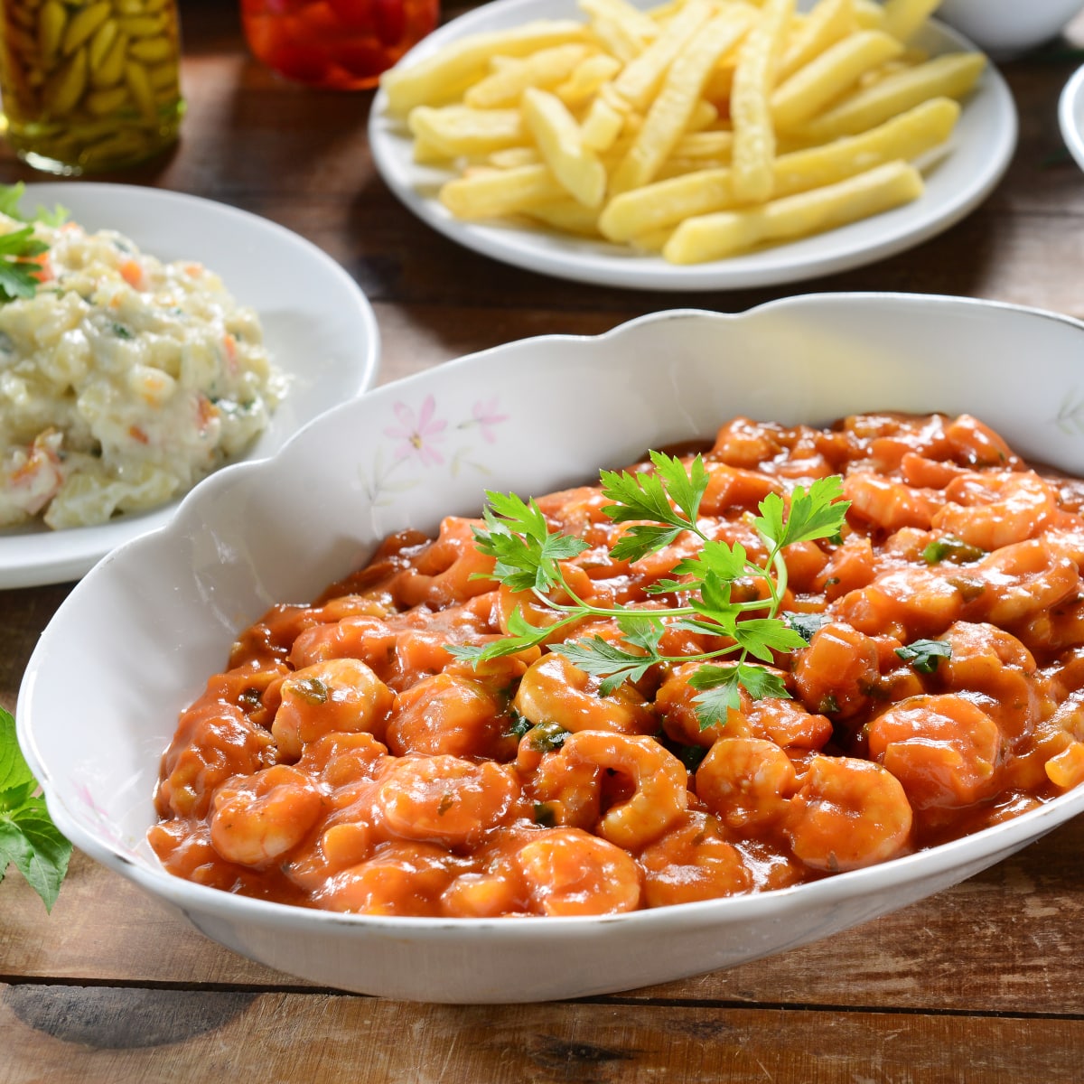 camarones a la diabla - spicy Mexican shrimp served in a white bowl with fries and slaw on the side