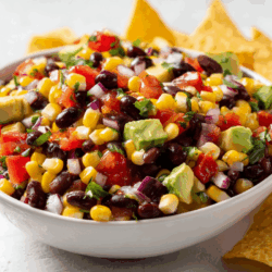 cowboy caviar in a white bowl with tortillas