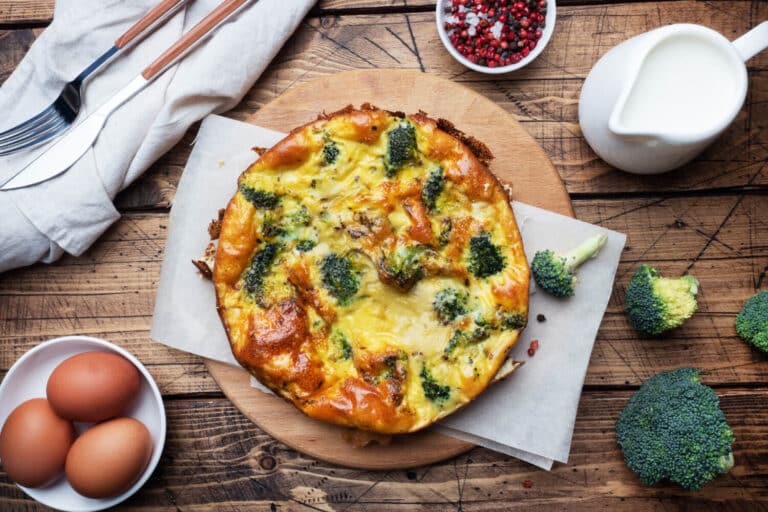 Crustless Quiche showing eggs, milk, salt, and pepper. Baked and ready to cut and serve.