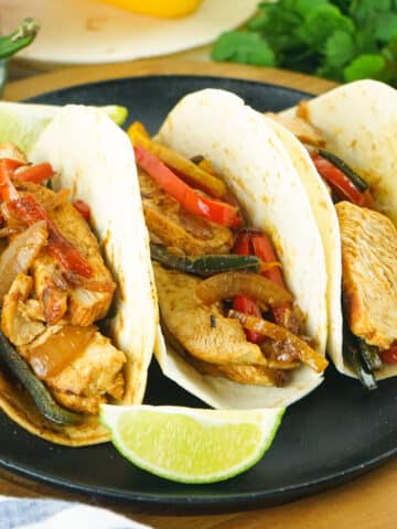 3 easy chicken fajitas recipe on a black plate