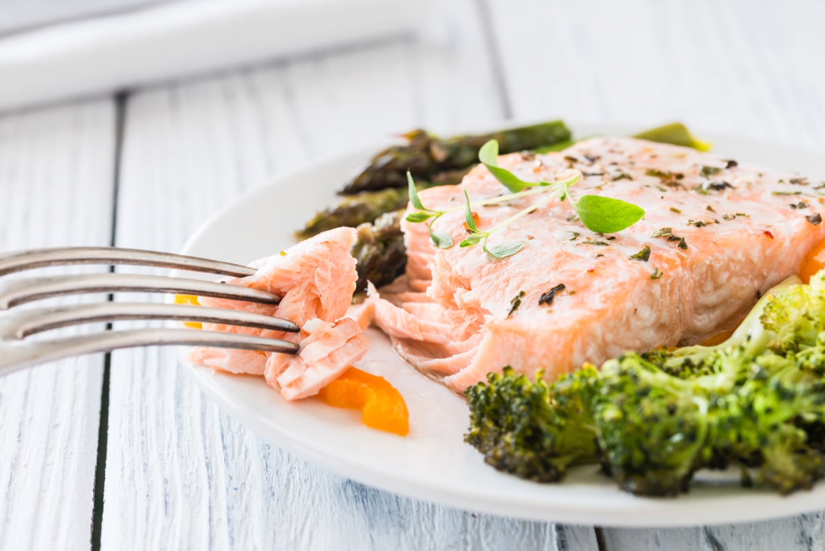 Showing baked salmon is done when it flakes easily when tested with a fork