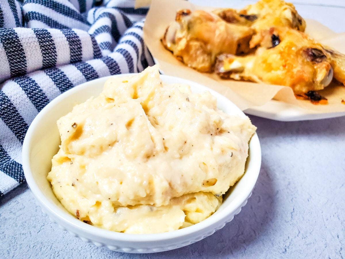 garlic parmesan dipping sauce next to a plate of wings