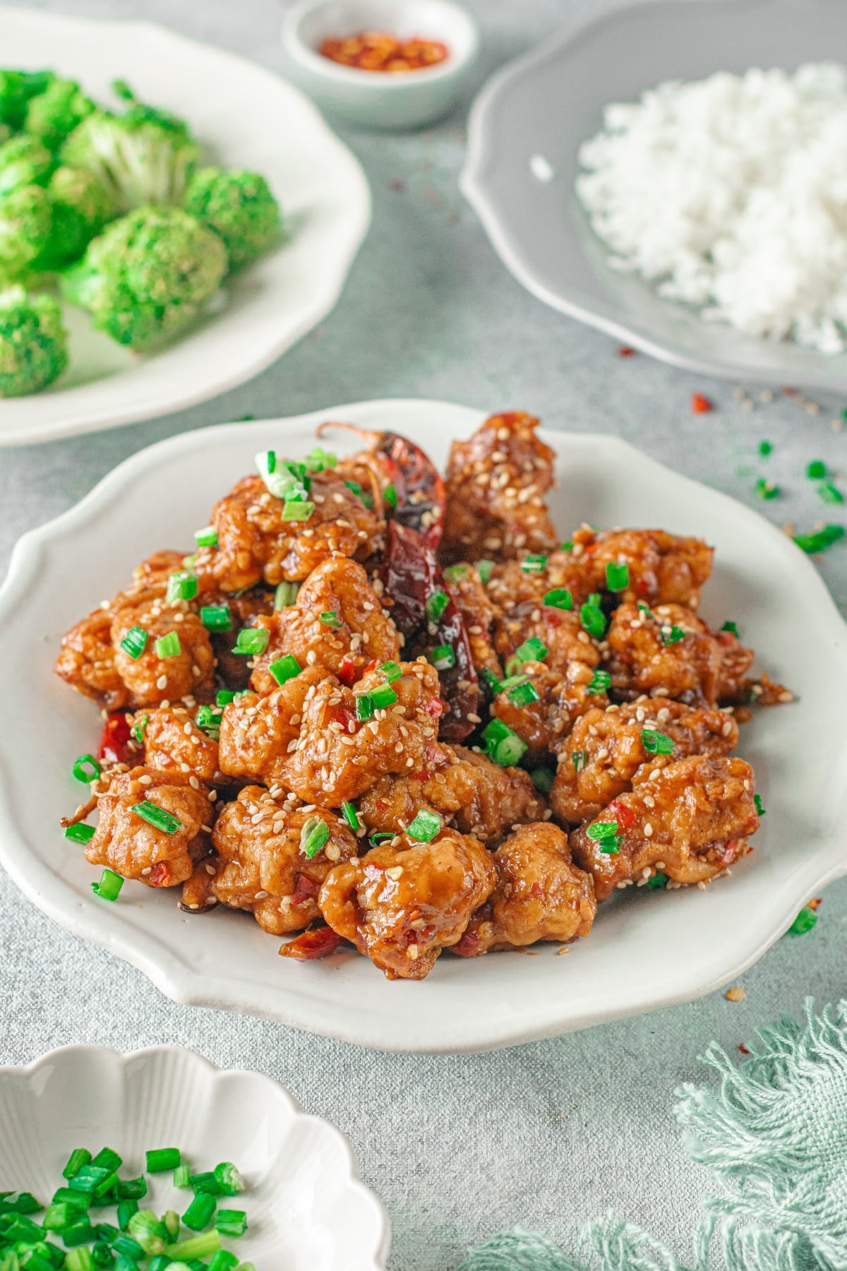 general tso's chicken recipe shown with side dishes
