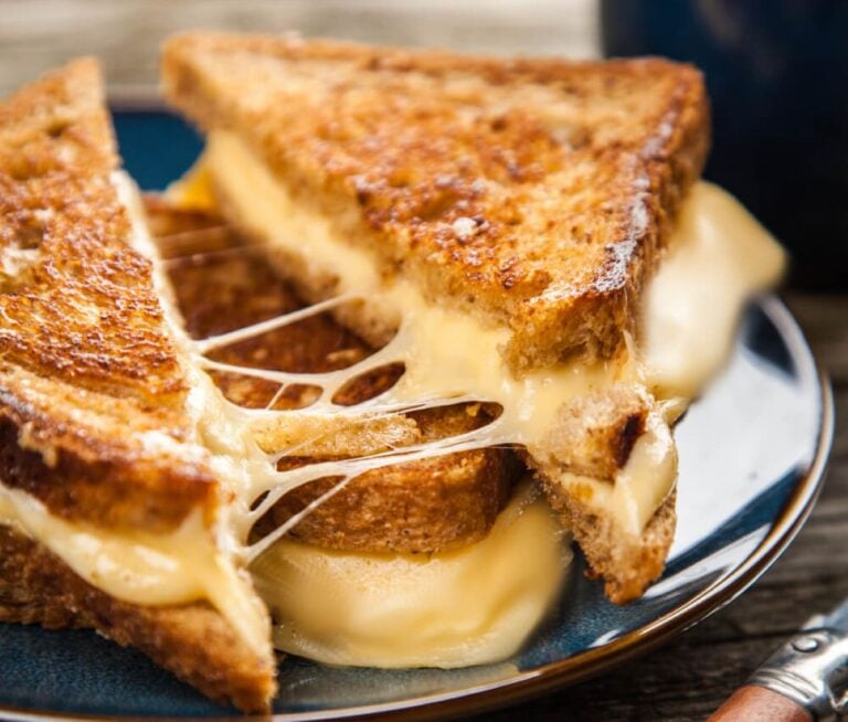 grilled cheese cup on the diagonal with gooey melted cheese showing