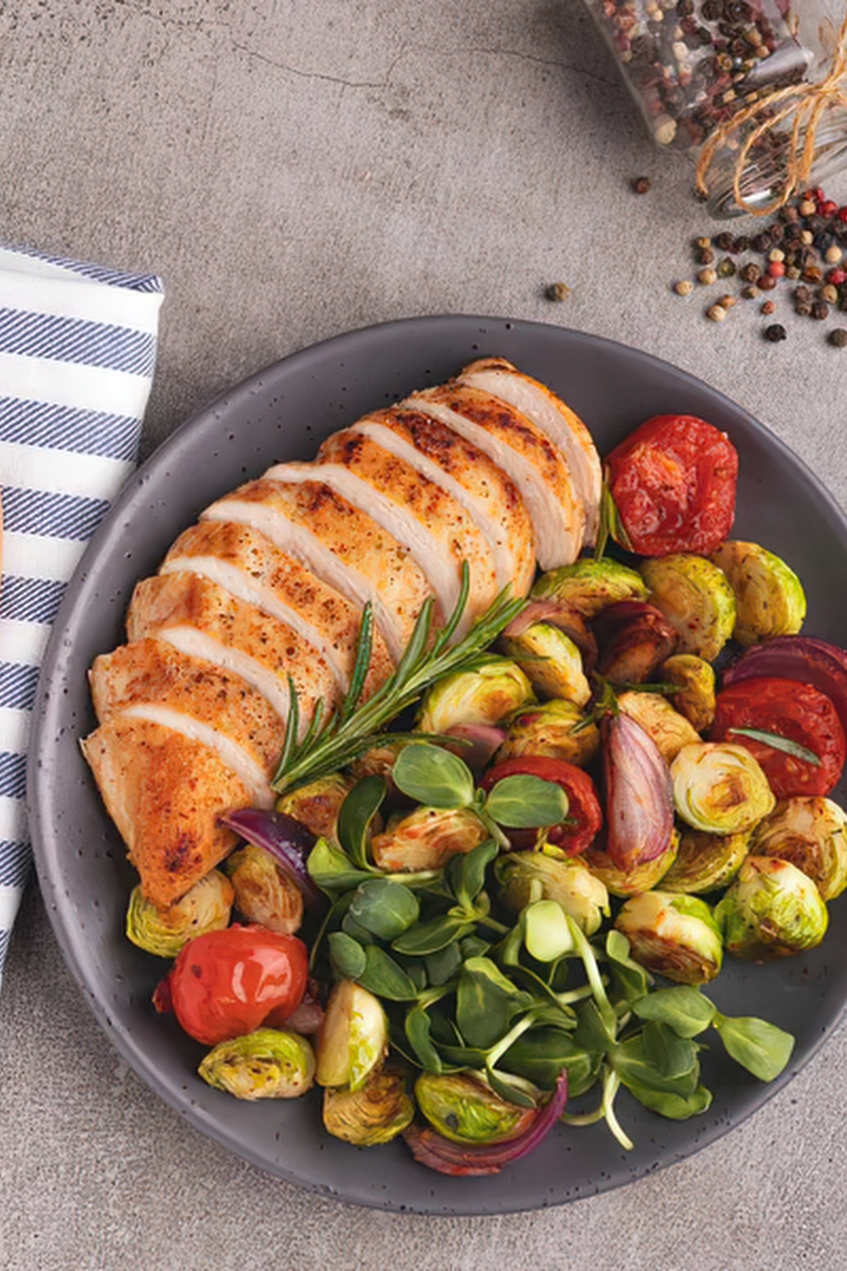 sliced grilled chicken breasts with vegetable sides