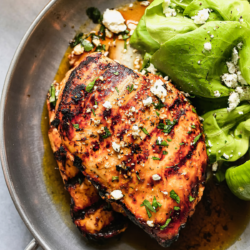 sliced grilled chicken breasts with vegetable sides