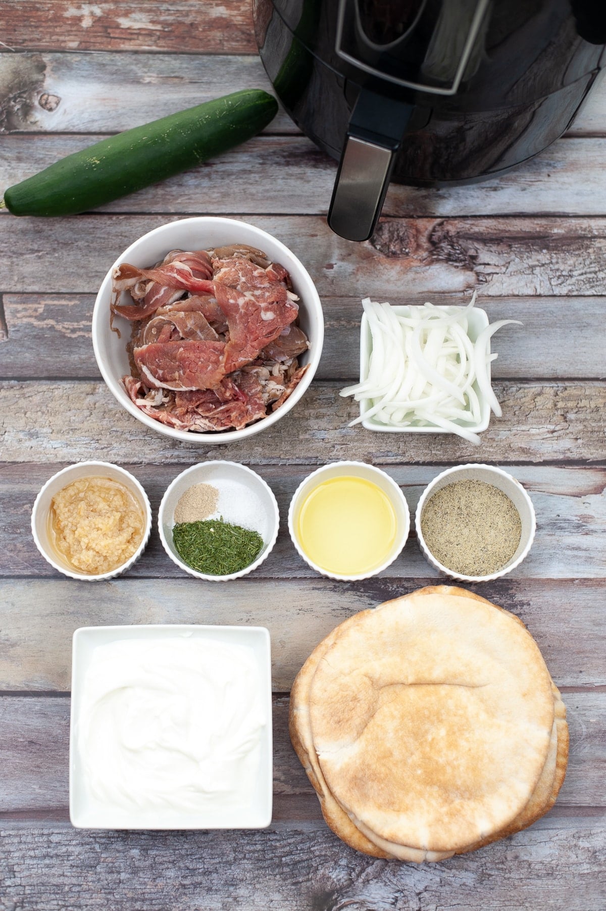 gyro sandwich ingredients on wooden table ready for preparation