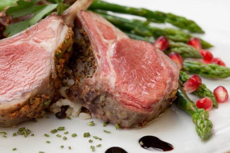 2 slices herb crusted rack of lamb served with asparagus