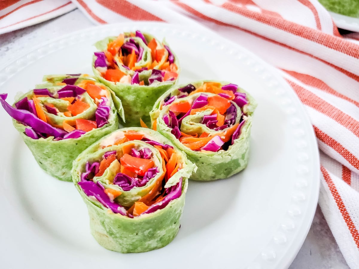 four hummus and veggie spinach pinwheel appetizers