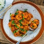 Spicy Hunan Shrimp served on pottery plate with speckles.