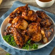 Mouthwatering Instant Pot BBQ Chicken plated with a bowl of bbq sauce on the side