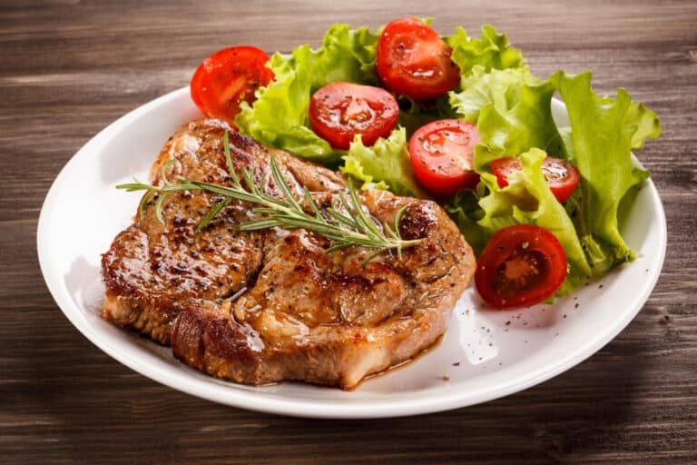 Instant Pot Pork Chop with a green side salad and tomatoes