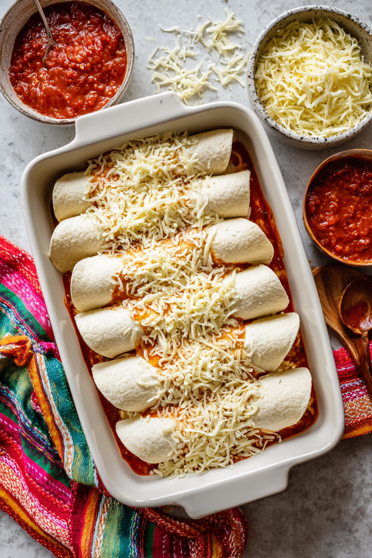 assembled chicken enchiladas in a baking dish