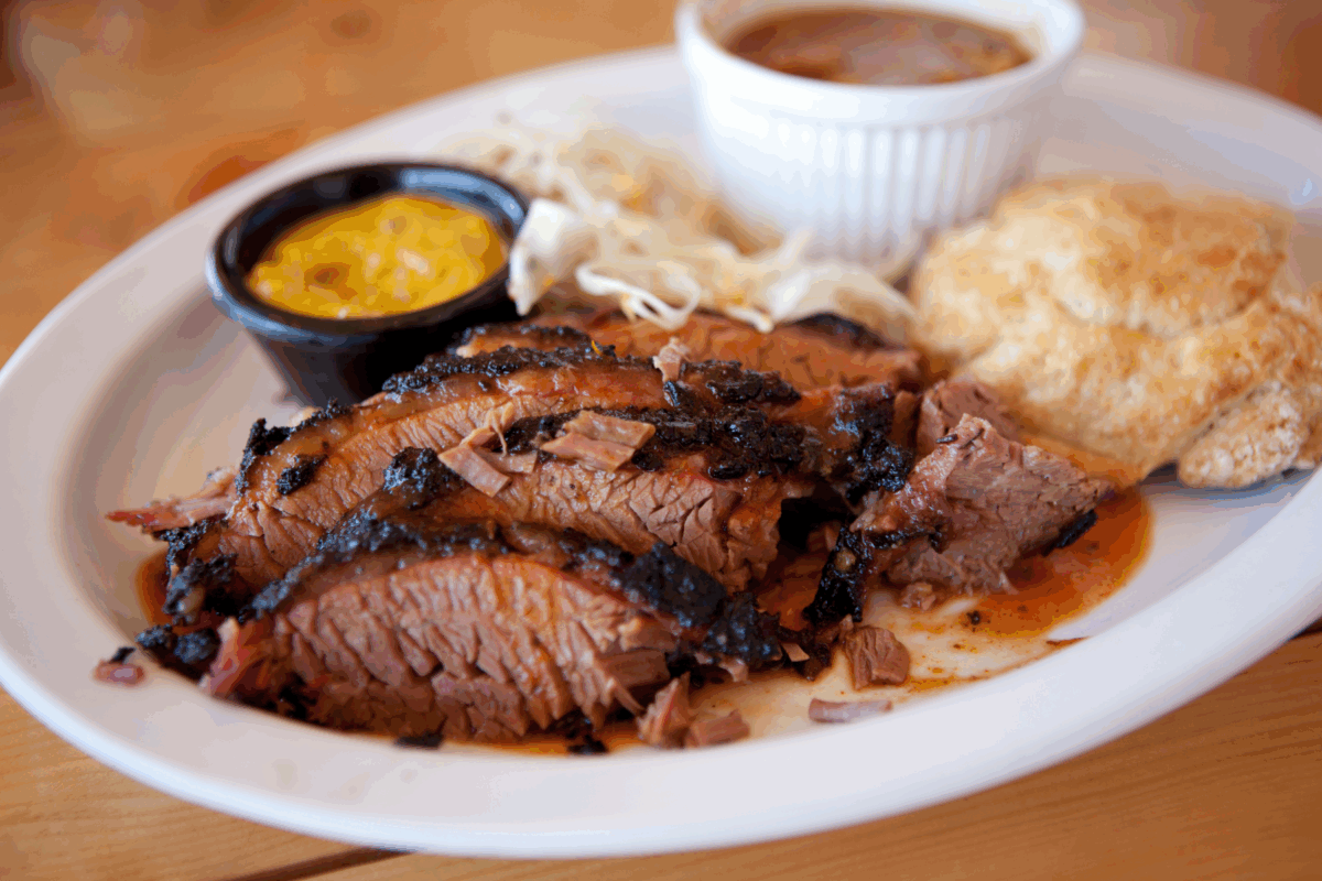 brisket served with side dishes and biscuit
