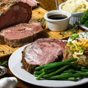 boneless prime rib roast slice served with side dishes.