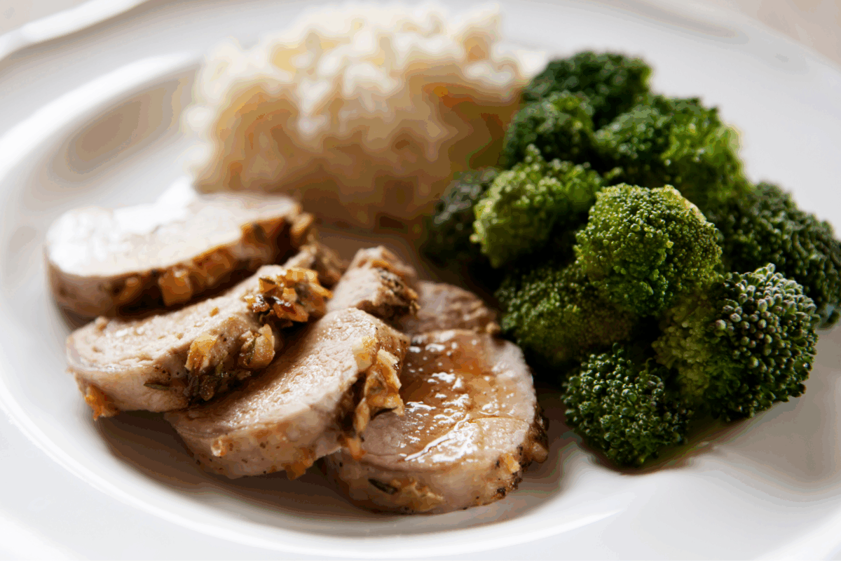 Instant Pot pork tenderloin served with broccoli and mashed potatoes.
