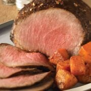 Eye of Round Roast closeup with sweet potato chunks on the side.