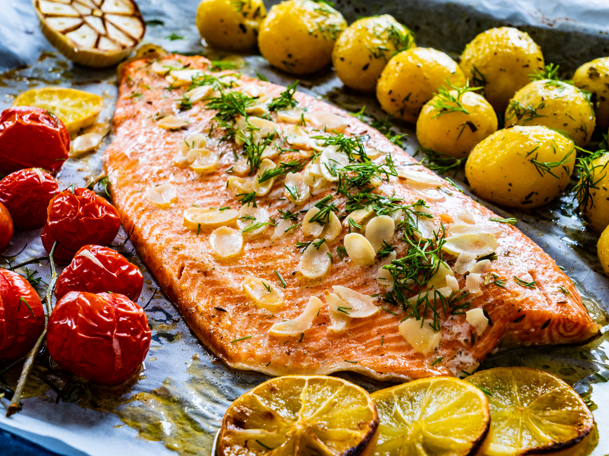 sheet pan salmon fillet with potatoes, tomatoes, herbs, garlic, lemon
