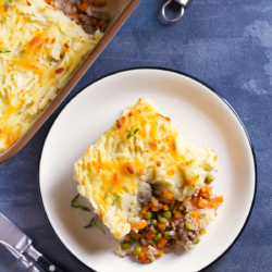 classic shepherds pie served on a white plate for Sunday dinner