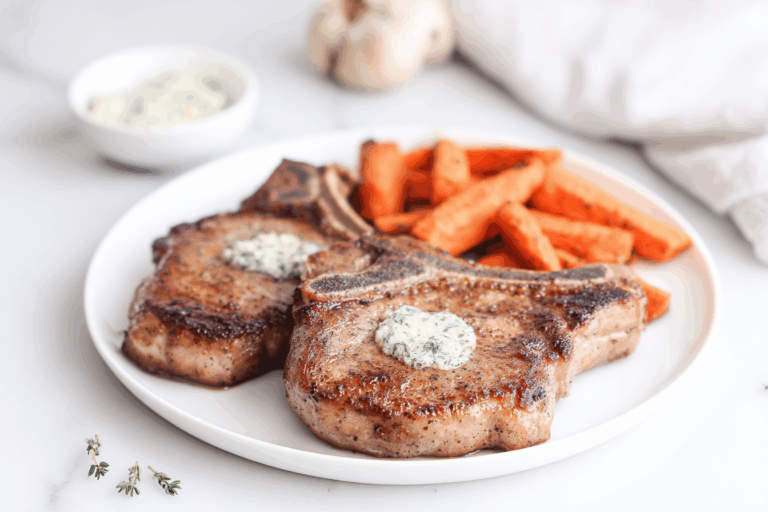 Air fryer dinners of pork chops and carrots with butter.