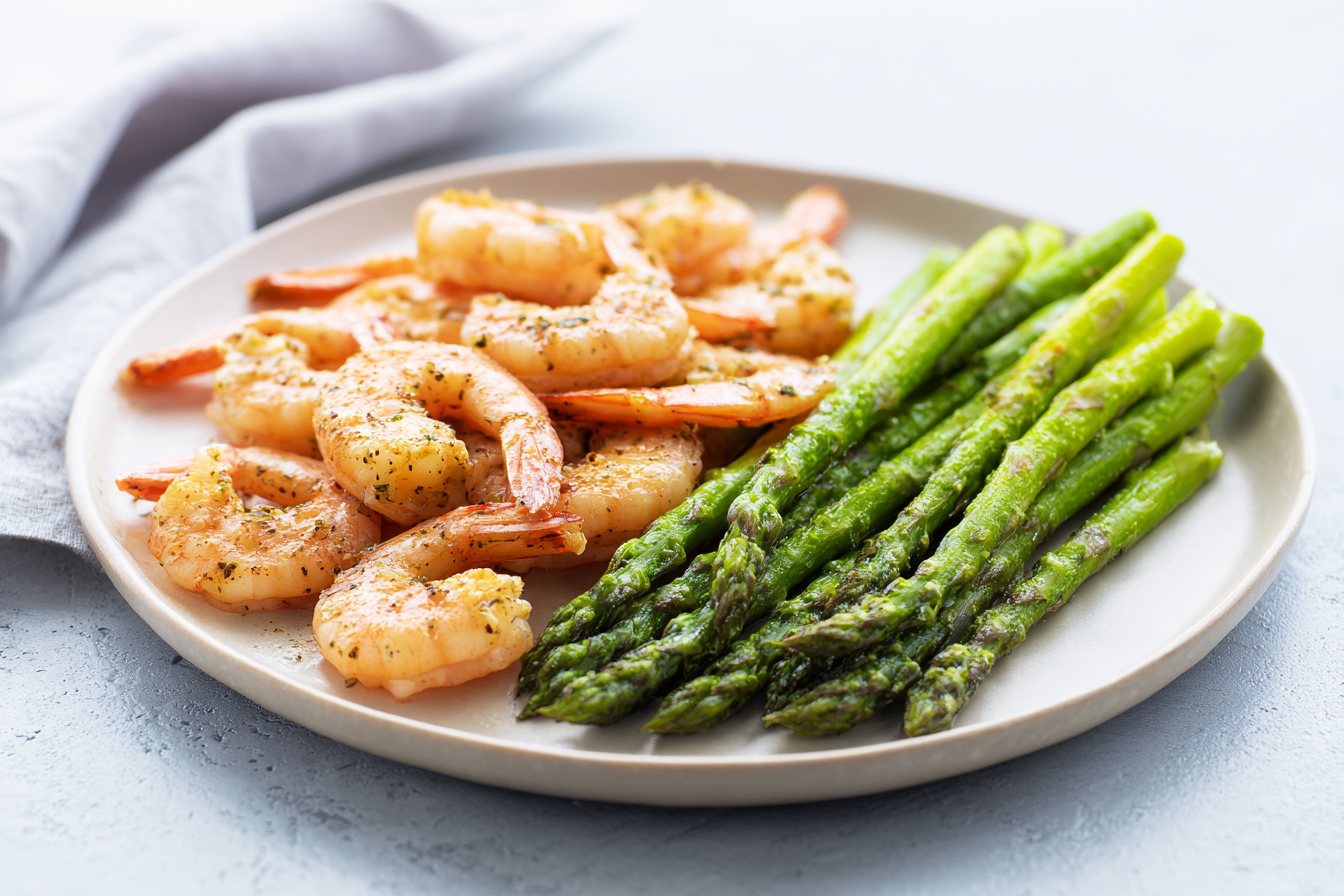 air fryer large shrimp and asparagus on a white plate