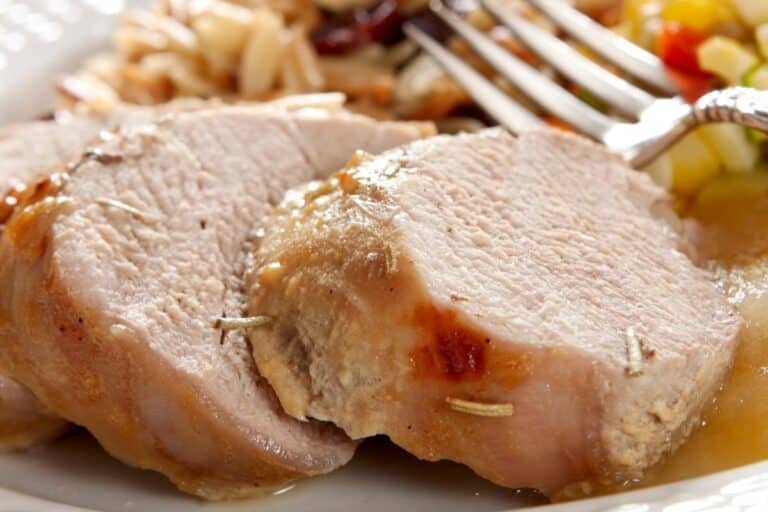 closeup of sliced ip pork tenderloin with fork