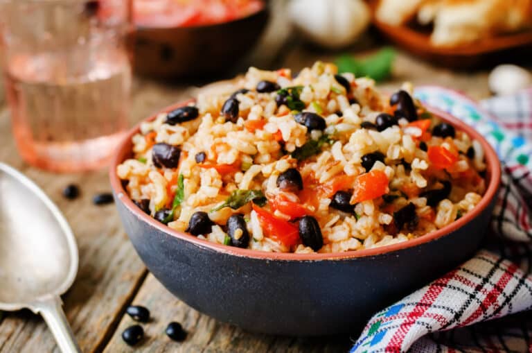 closeup of spanish beans and rice in a rustic bowl