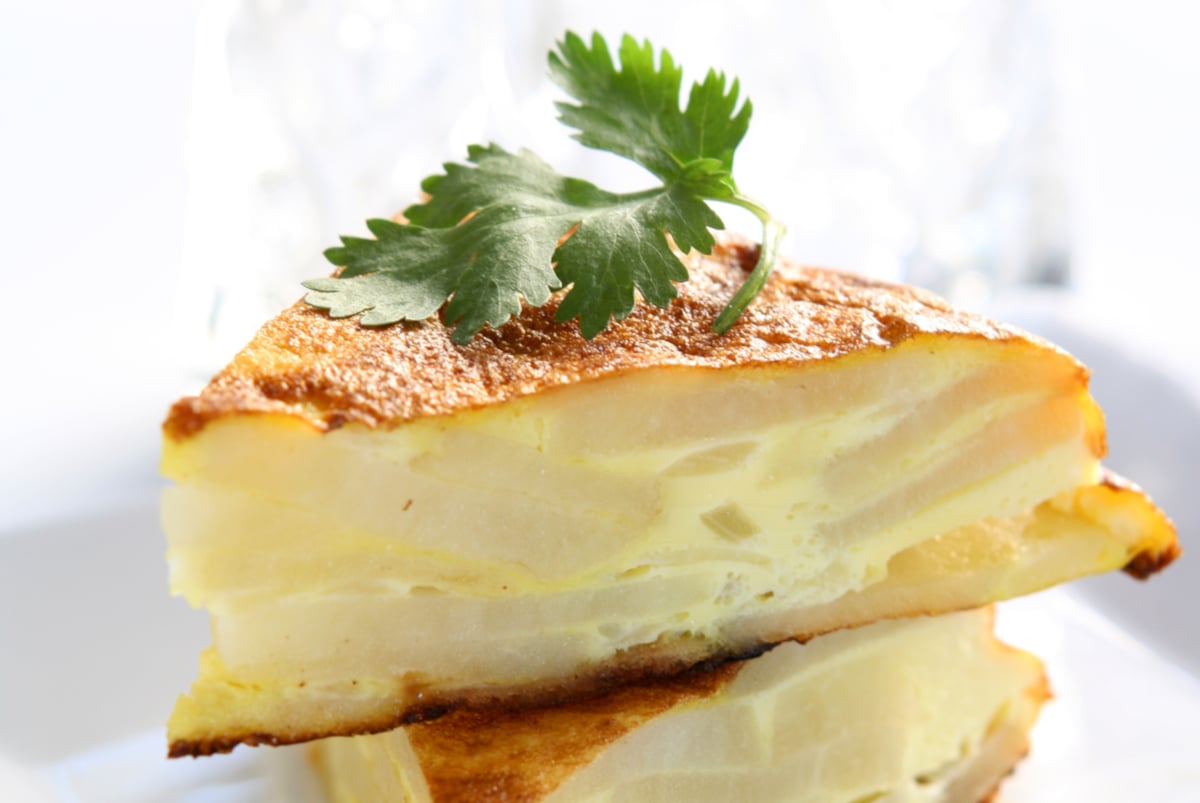 Spanish omelette made of layers of potatoes cooked in a skillet for appetizers or breakfast