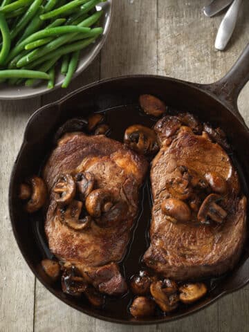 stove top cast iron skillet with ribeye steak