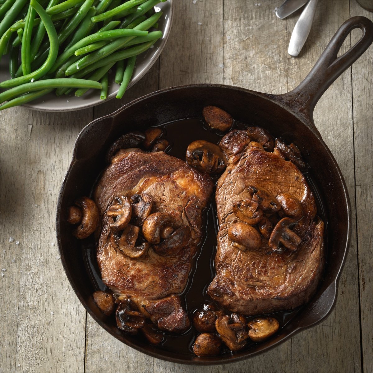 stove top cast iron skillet with ribeye steak