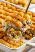 Tater Tot Casserole With Ground Beef tater to casserole being ladeled from the casserol dish
