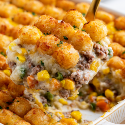 tater to casserole being ladeled from the casserol dish