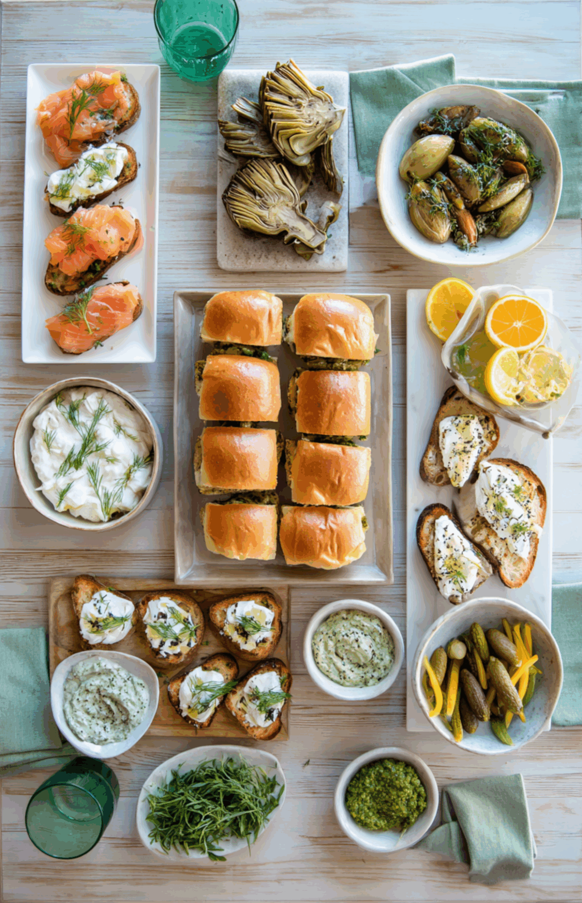 West Coast themed game day spread with tri tip sliders, smoked salmon, shrimp, artichokes, and dip